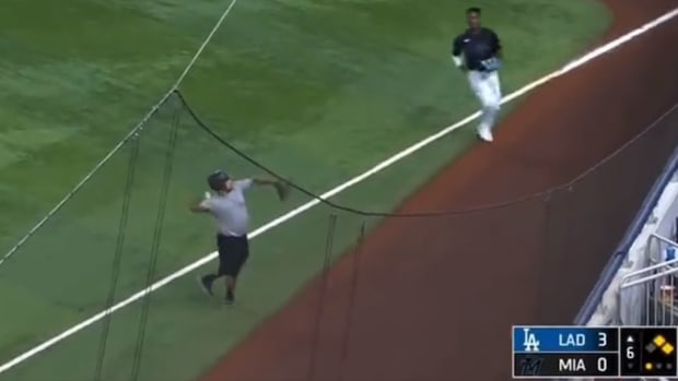 A Miami Marlins ball boy throws a live ball into the stands on Sept. 7, 2023.